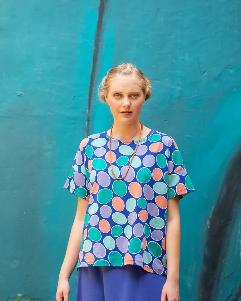 A woman wearing a dotted top from Gudrun Sjödén.  