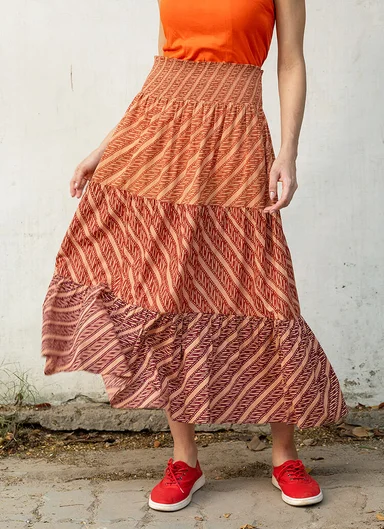 A woman wearing a patterned skirt from Gudrun Sjödén.  