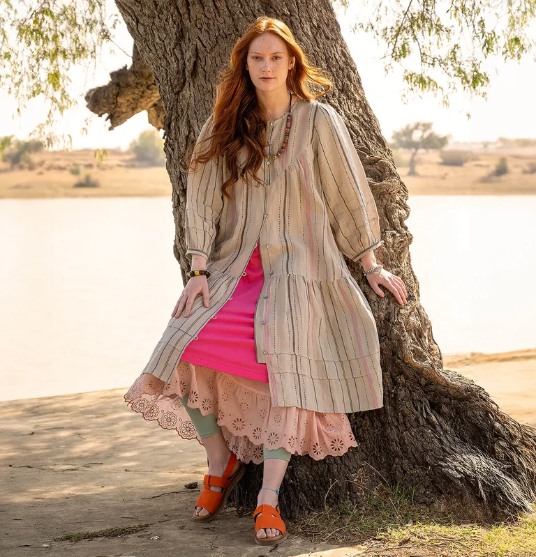 A woman wearing a linen blouse from Gudrun Sjödén.