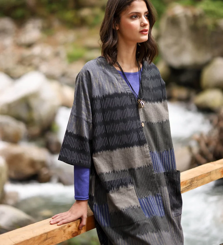 A woman wearing a patterned dress from Gudrun Sjödén.