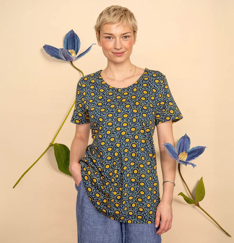 A woman wearing a colourful floral top from Gudrun Sjödén. 