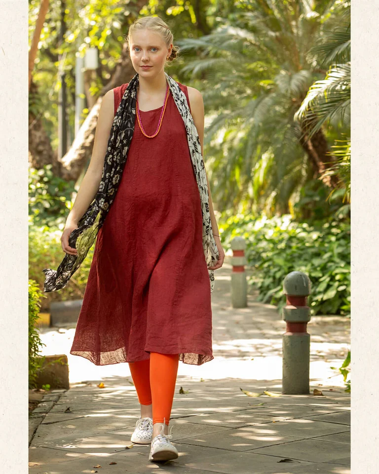 A woman wearing a red dress from Gudrun Sjödén.  