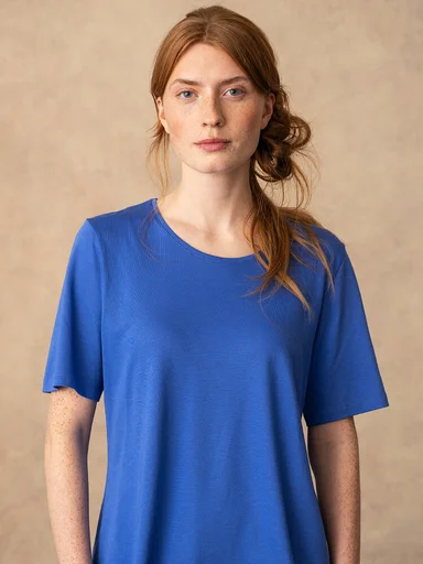A woman wearing a blue top from Gudrun Sjödén. 