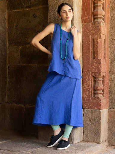A woman wearing a blue tank top and skirt from Gudrun Sjödén. 