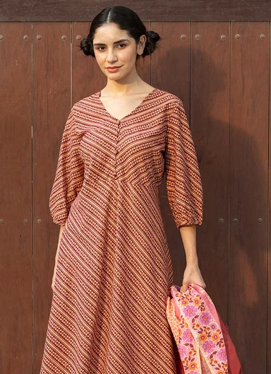 A woman wearing a striped dress from Gudrun Sjödén.  