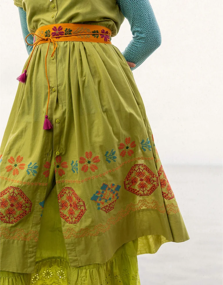 A woman wearing a patterned dress from Gudrun Sjödén.