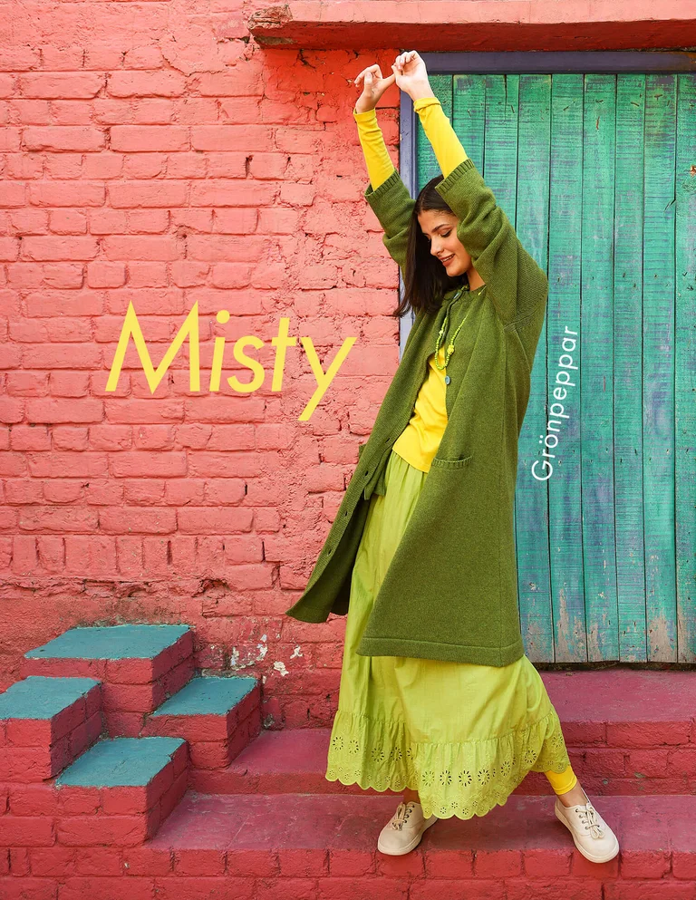 A woman wearing a green cardigan from Gudrun Sjödén. 