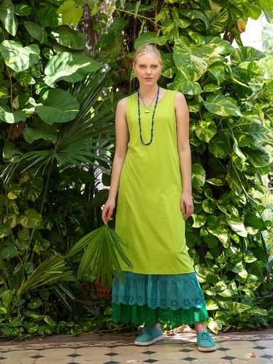 A woman wearing a green dress from Gudrun Sjödén.  