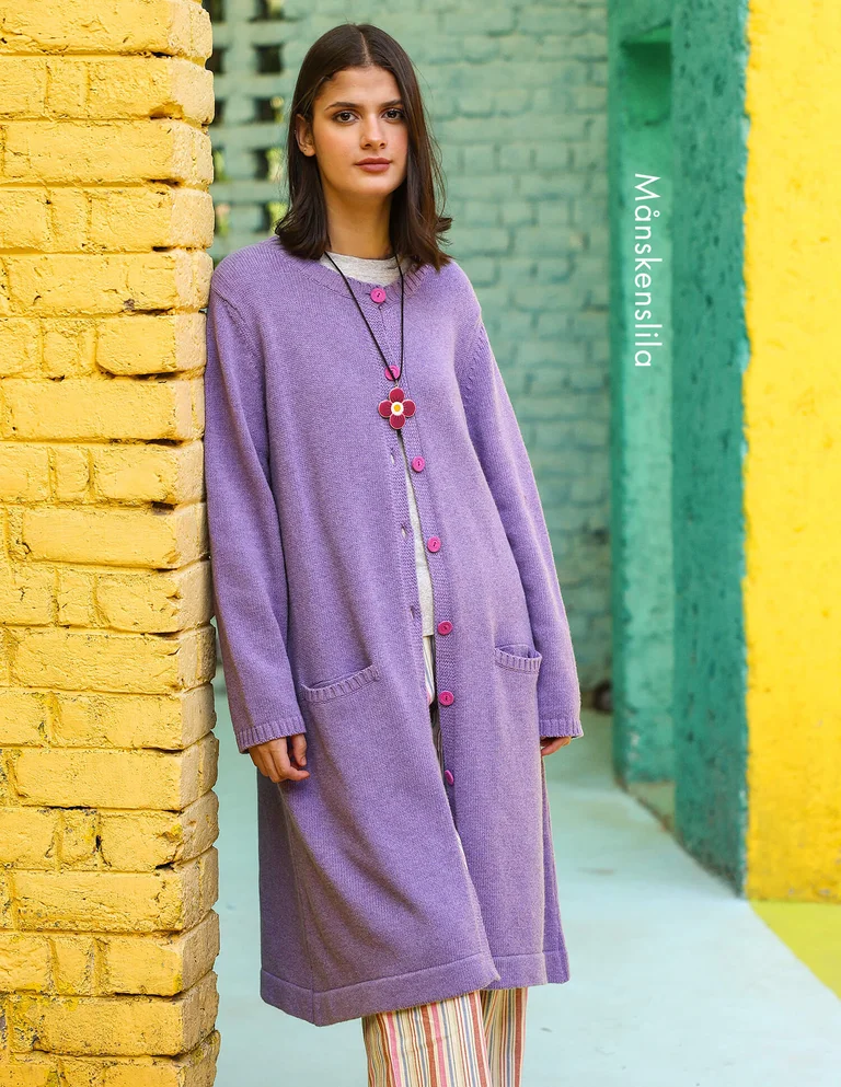 A woman wearing a purple cardigan from Gudrun Sjödén.