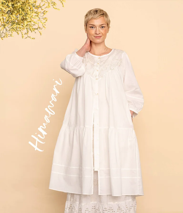 A woman wearing a white dress from Gudrun Sjödén.