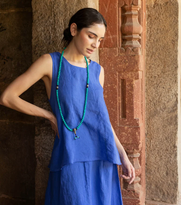 A woman wearing a tank top and skirt from Gudrun Sjödén. 