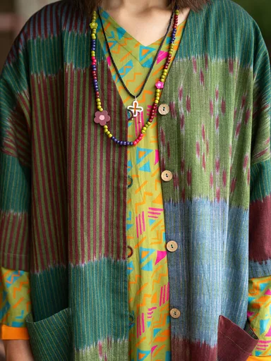 A woman wearing a patterned dress and necklace from Gudrun Sjödén.