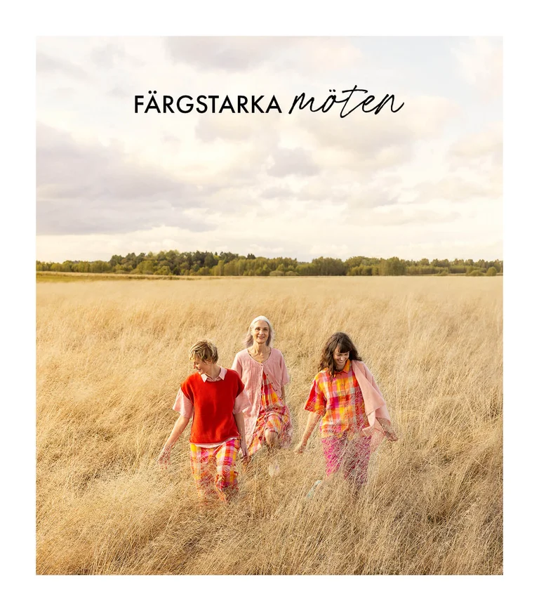 Three women wearing colourful creations from Gudrun Sjödén. 