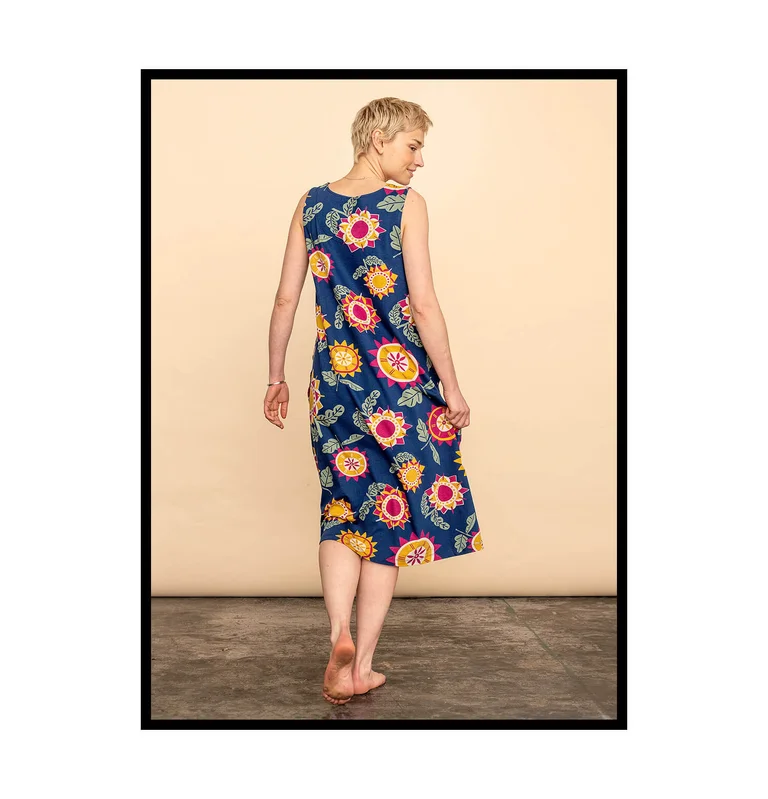 A woman wearing a colourful floral dress from Gudrun Sjödén. 