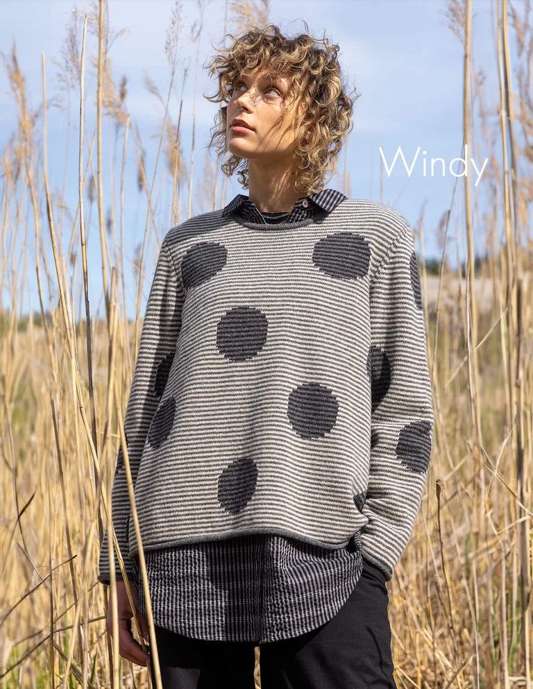 A woman wearing a striped and dotted sweater from Gudrun Sjödén.