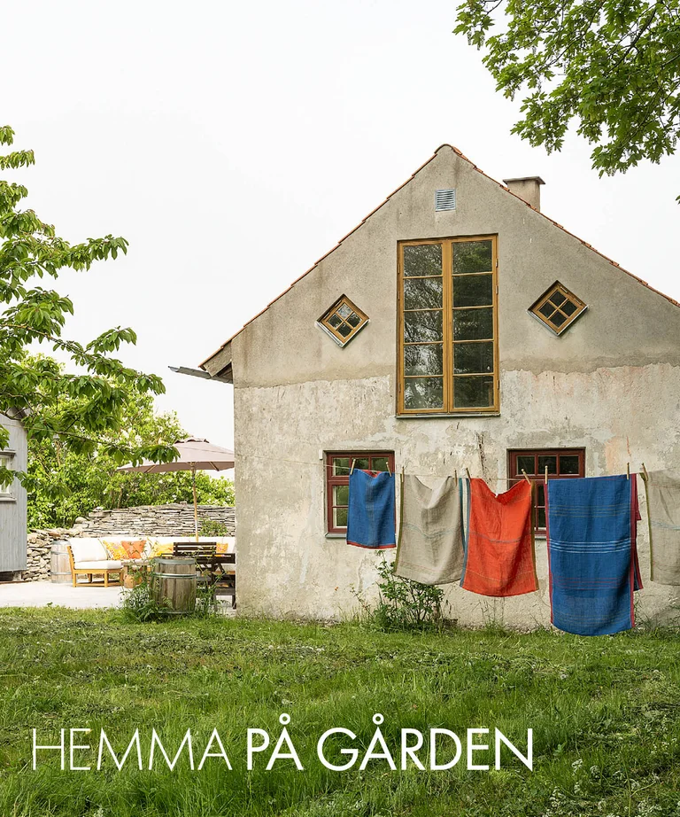 A lime-plastered house on Gotland with home textiles from Gudrun Sjödén on a clothesline.