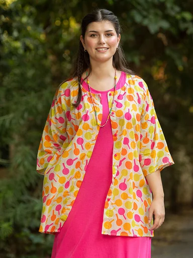 A woman wearing a patterned blouse from Gudrun Sjödén. 